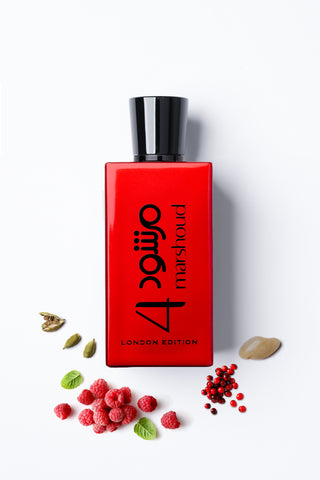 Marshoud4 Red perfume bottle with black cap on a white background, surrounded by small green leaves and red berries by Atyab Al Marshoud